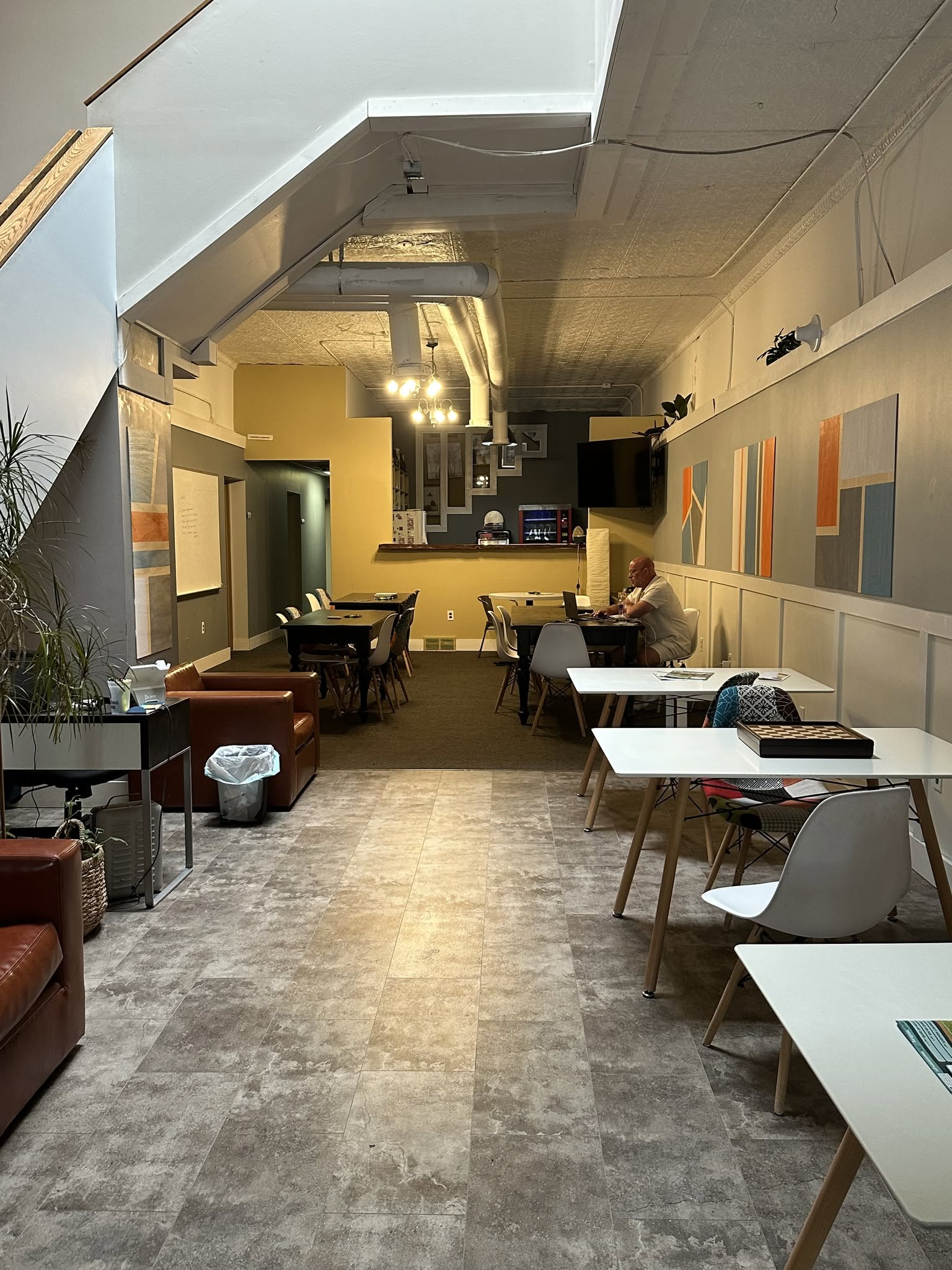 Open co-working space with shared desks and colorful art